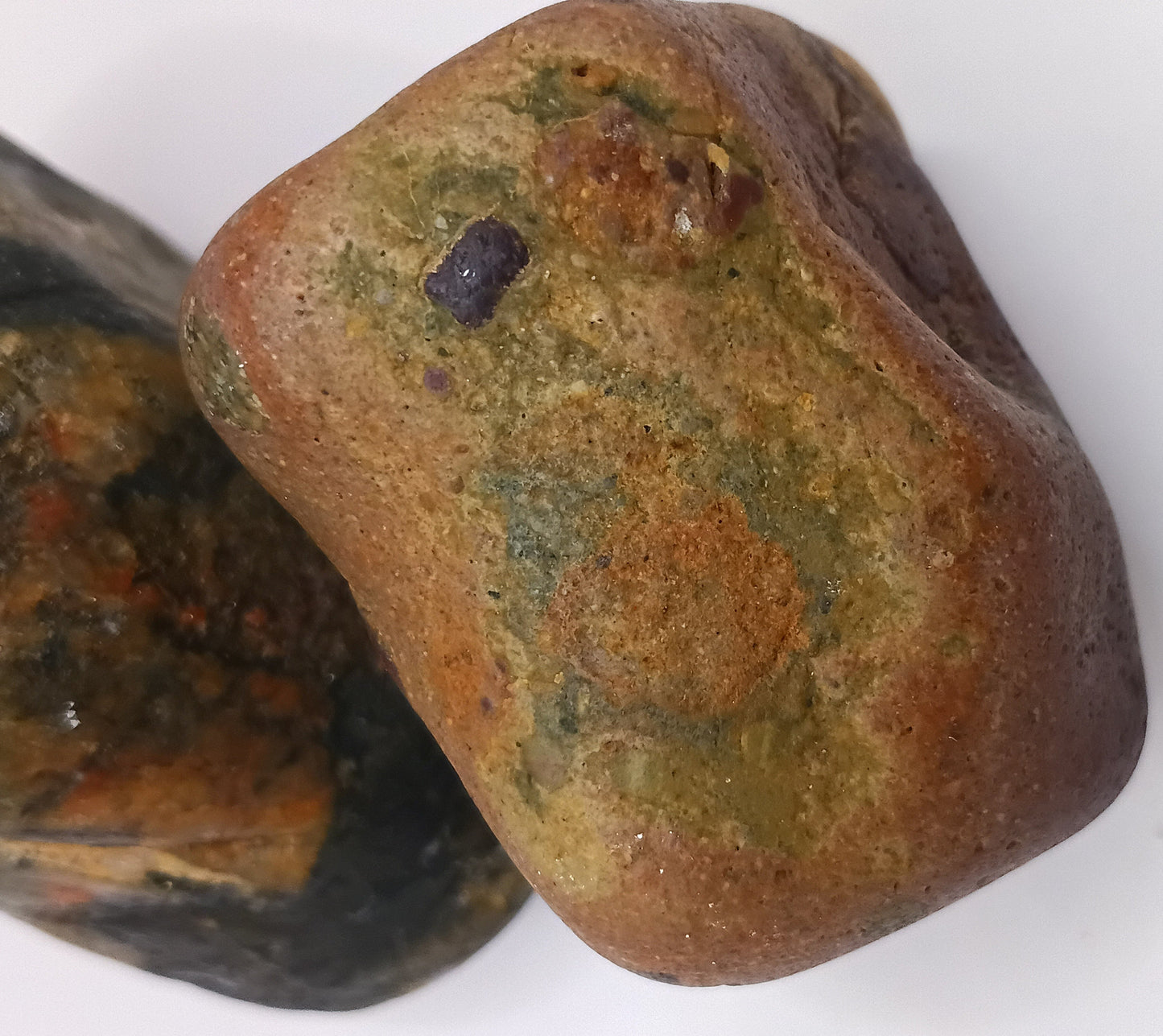 Two Plymouth beach stones — warm and cool tones paired together