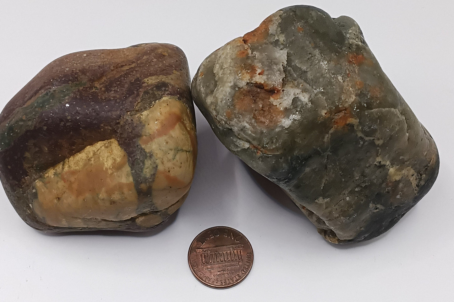 Nathaniel and Sophia Hawthorne Love Stones displayed on driftwood with penny for scale